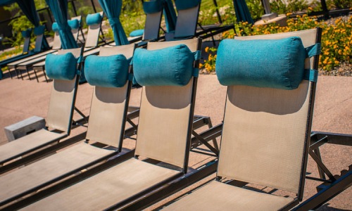 Lounge chairs poolside to Roadrunner on McDowell's resort-style pool